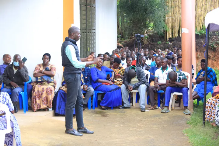 A speaker addressing participants at a community gathering.