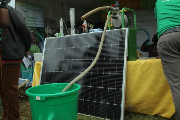 Solar panels and equipment displayed at an agricultural exhibition.